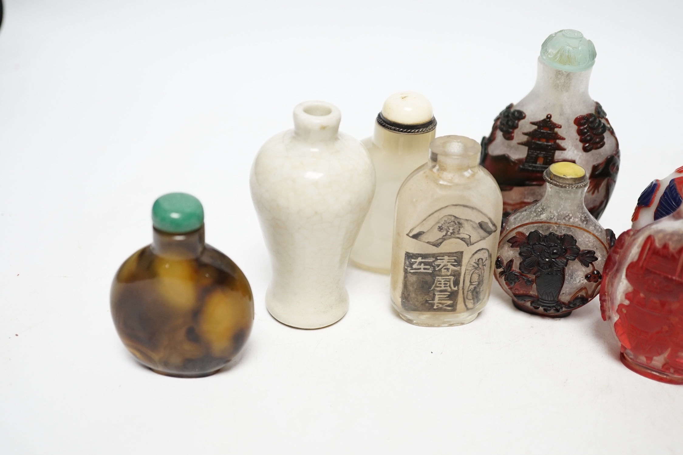 A group of Chinese cameo glass and inside painted glass and faux hardstone glass snuff bottles, largest 8.5cm high